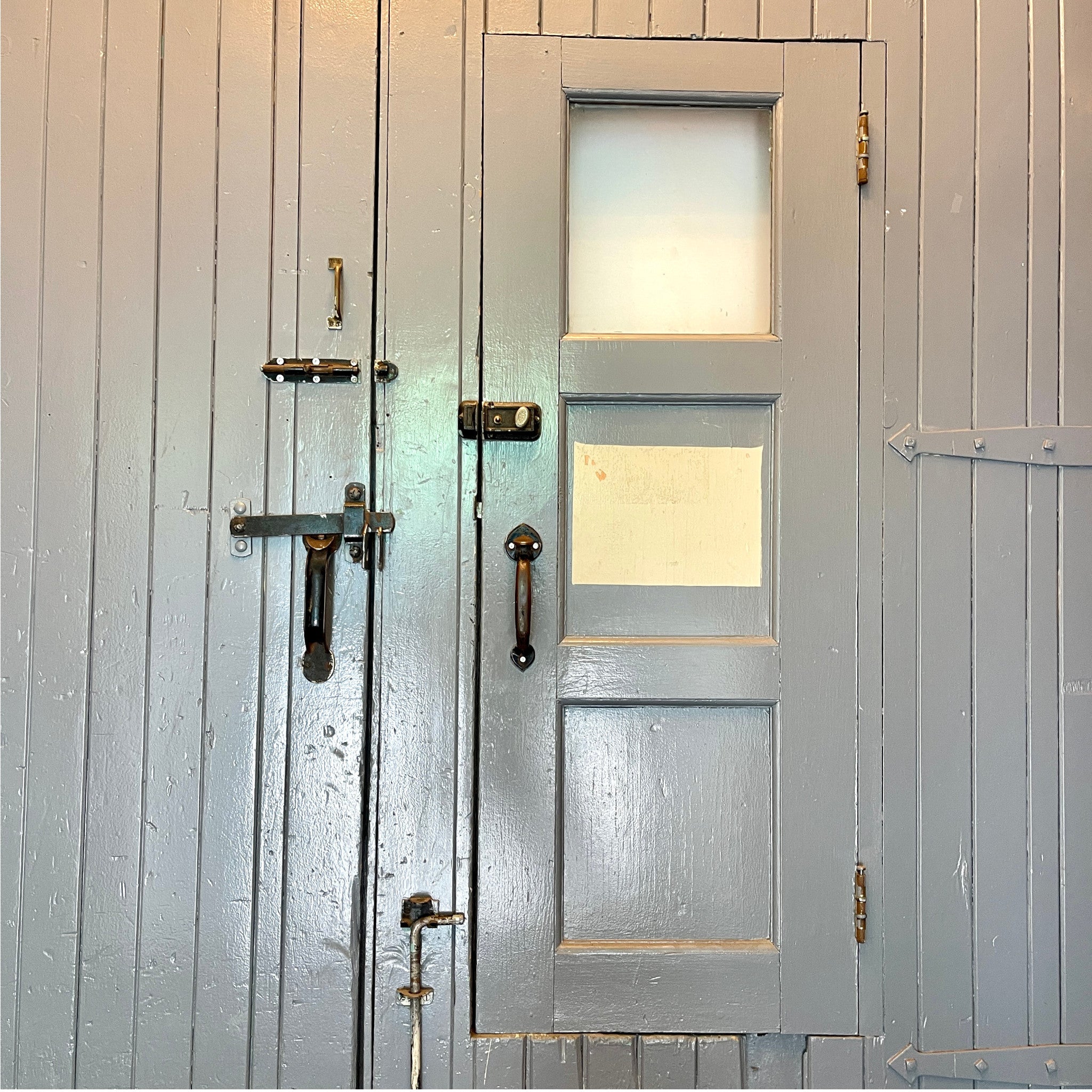 Pair of Oversized Vintage Industrial Wood Doors With Wicket Door