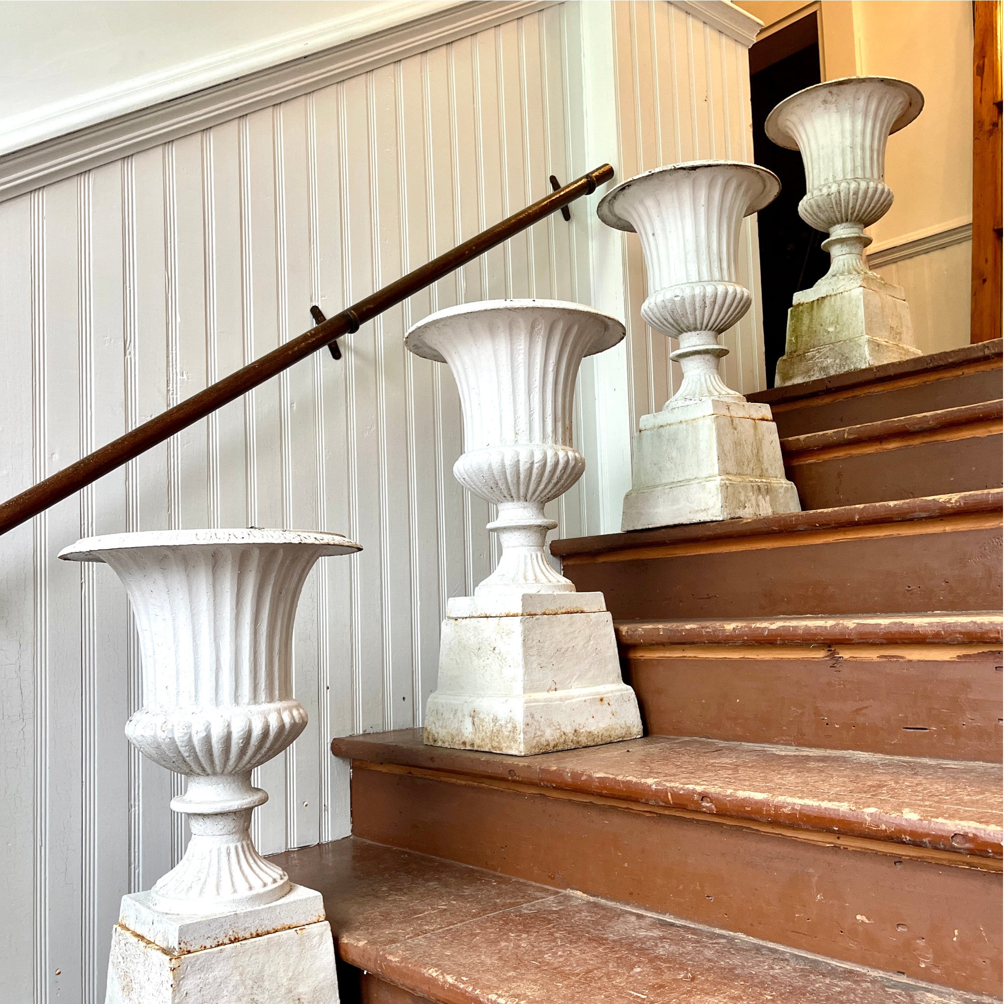 Set of Four Cast Iron Campana Urns with Matching Plinths