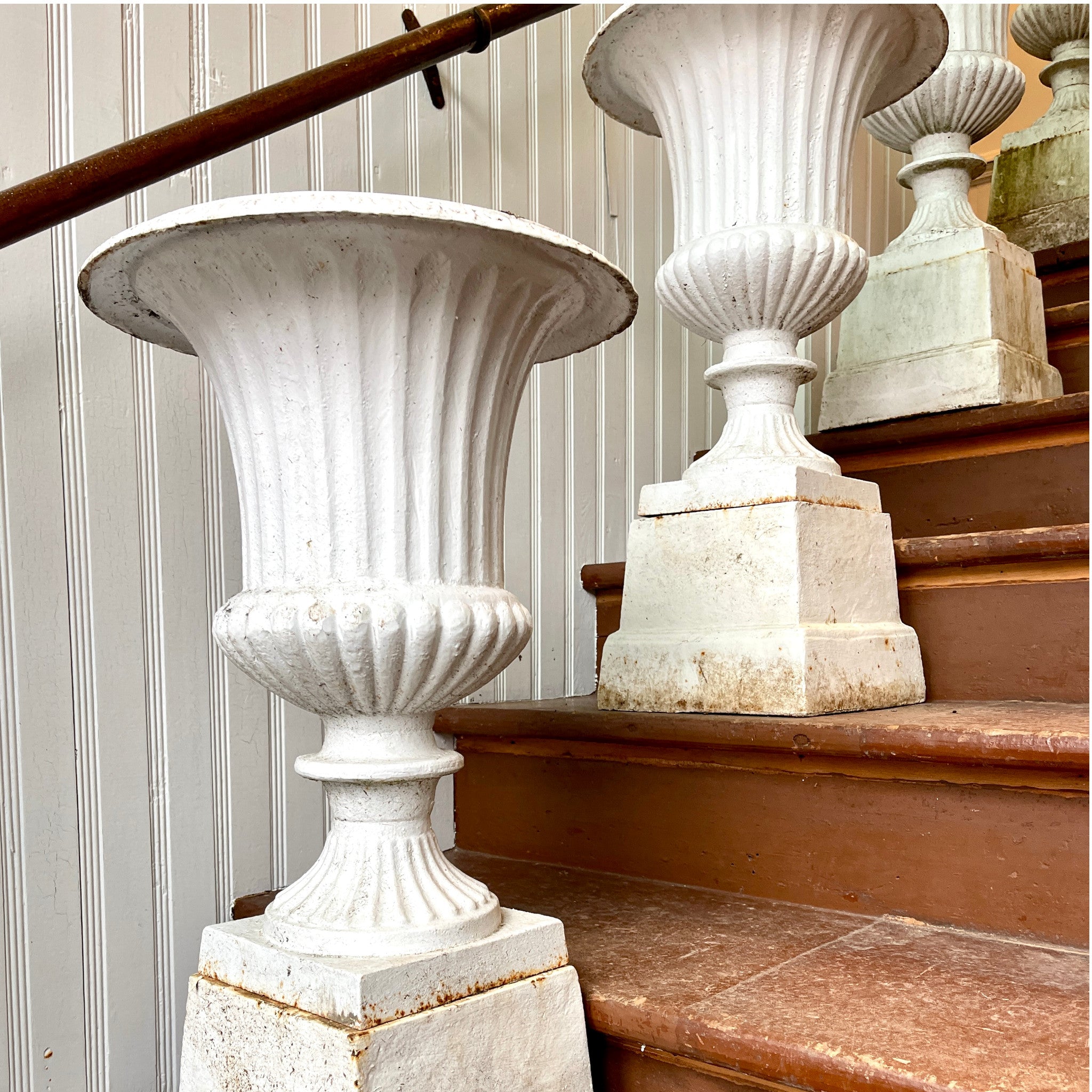 Set of Four Cast Iron Campana Urns with Matching Plinths