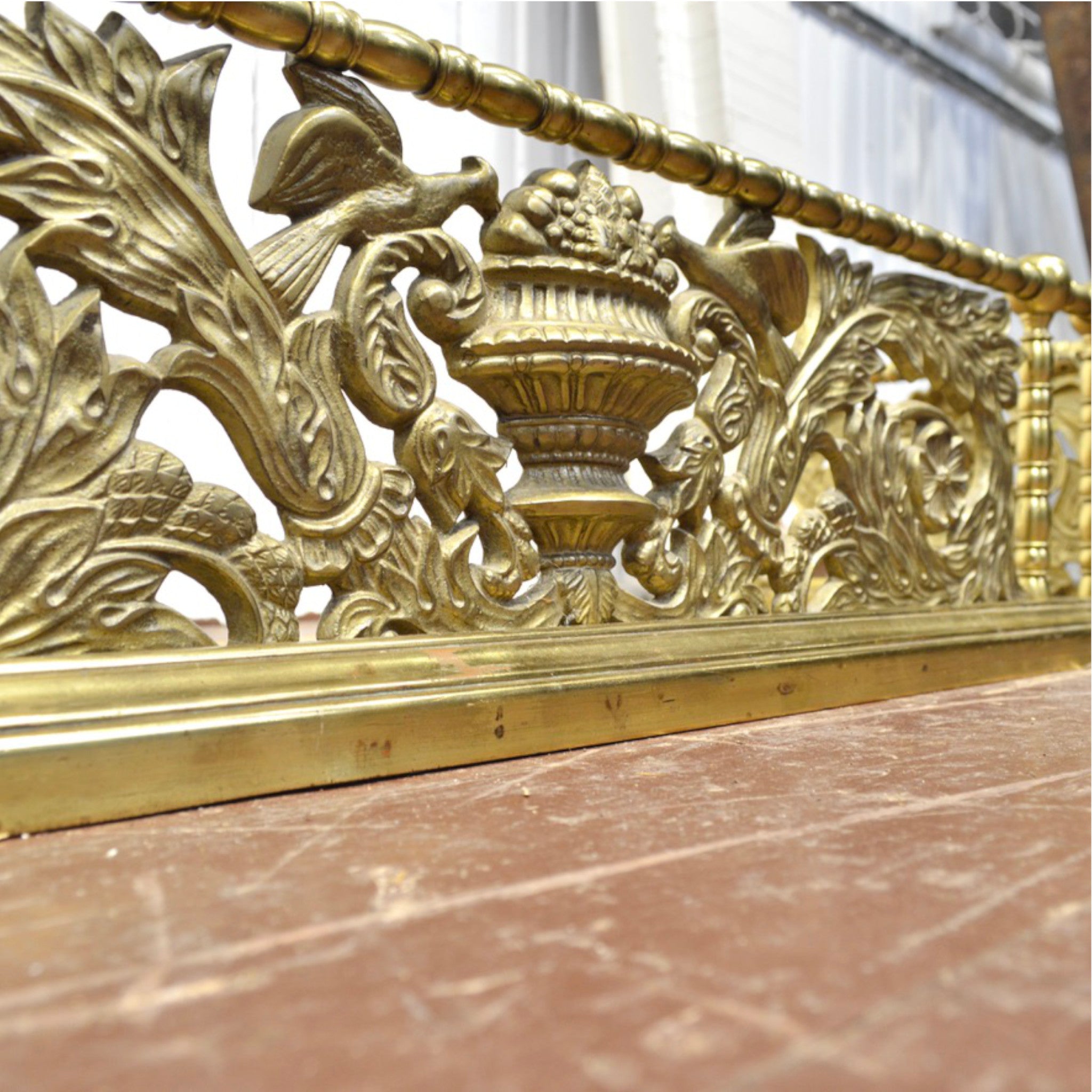 Vintage brass fireplace fender — classical urn motif