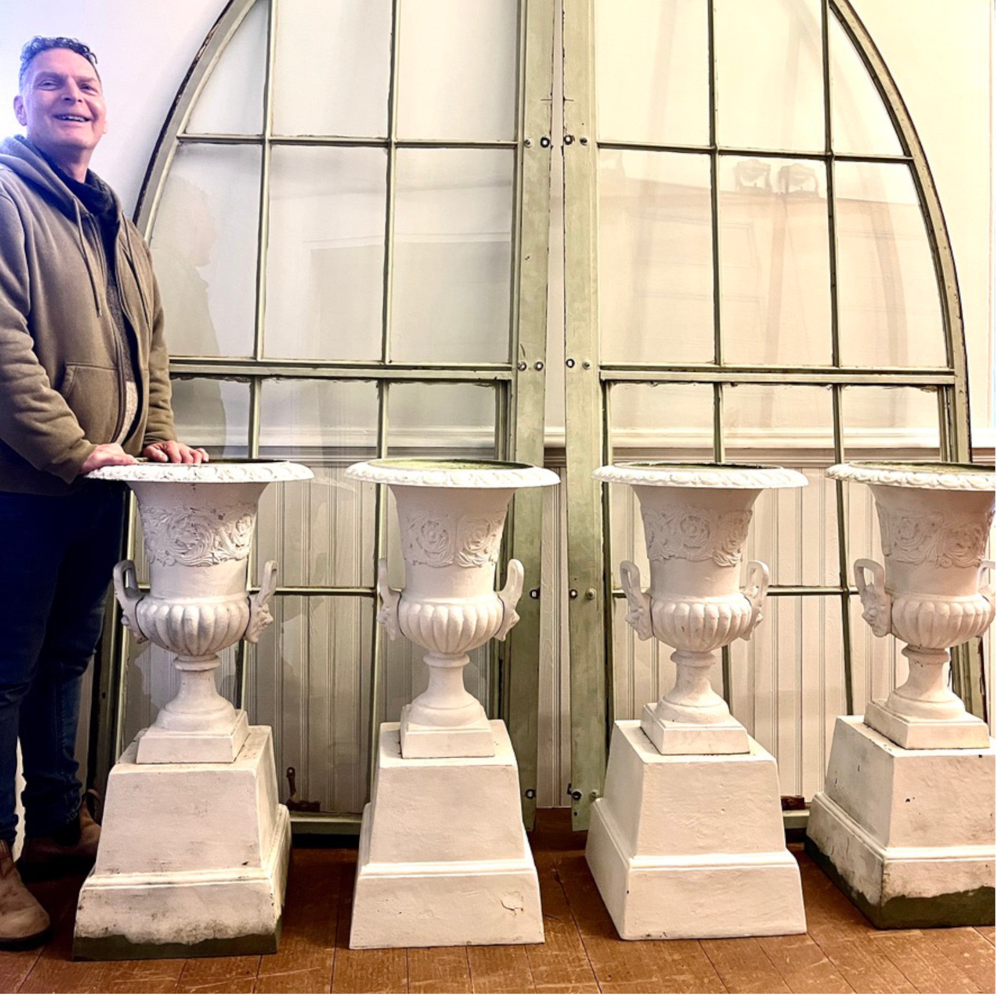 Set of Four Cast Iron Garden Urns with Lion Mask Handles on Plinths