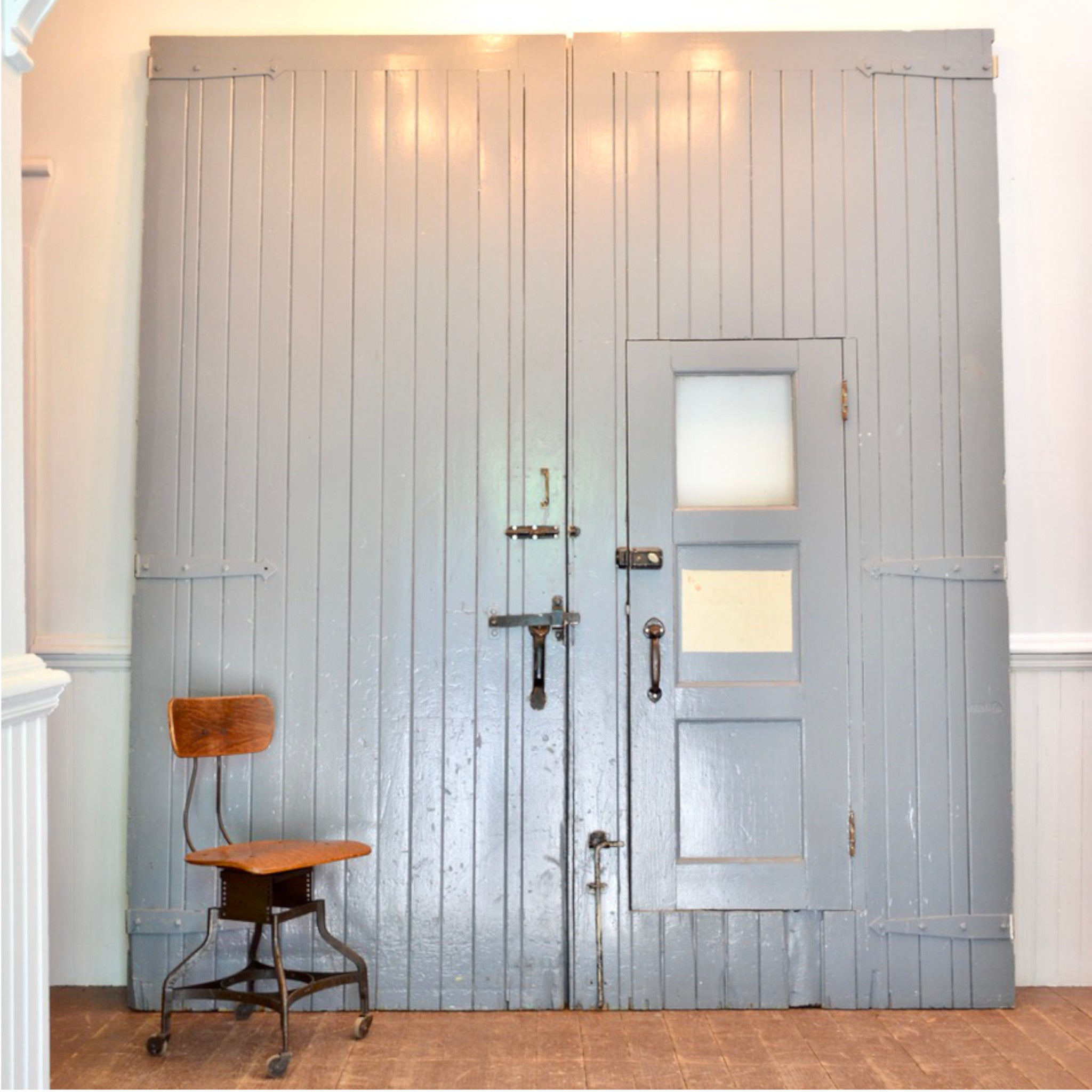 Pair of Oversized Vintage Industrial Wood Doors With Wicket Door